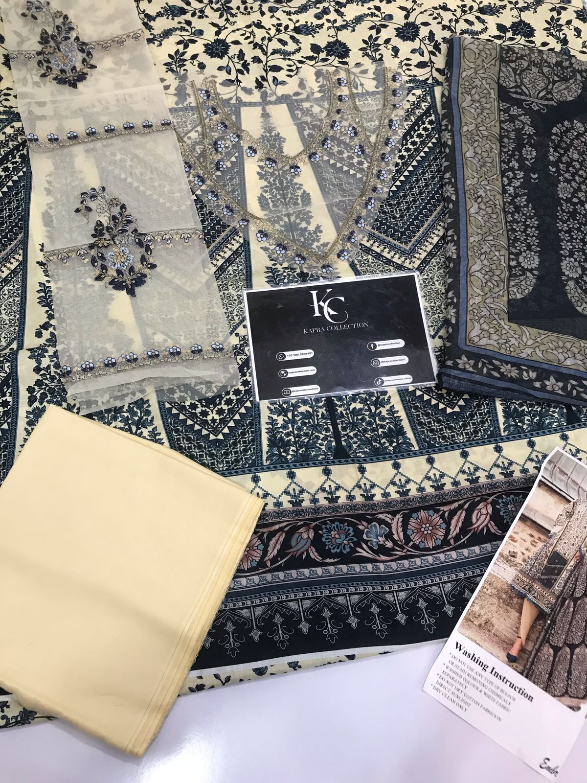 3-piece unstitched printed lawn suit in the "M print" style. These are typically fabric sets for making summer outfits The three pieces usually include: - Kapra Collection